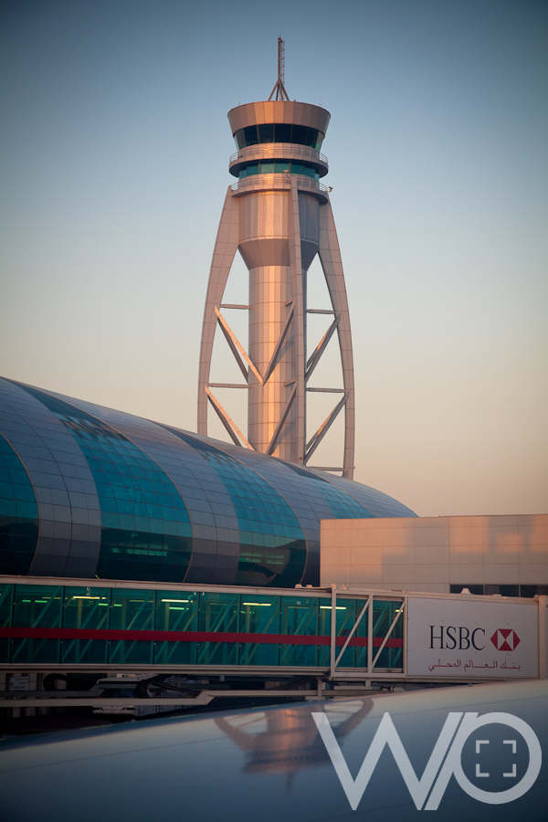 Sunrise at departure from Dubai - control tower glistening in the sun